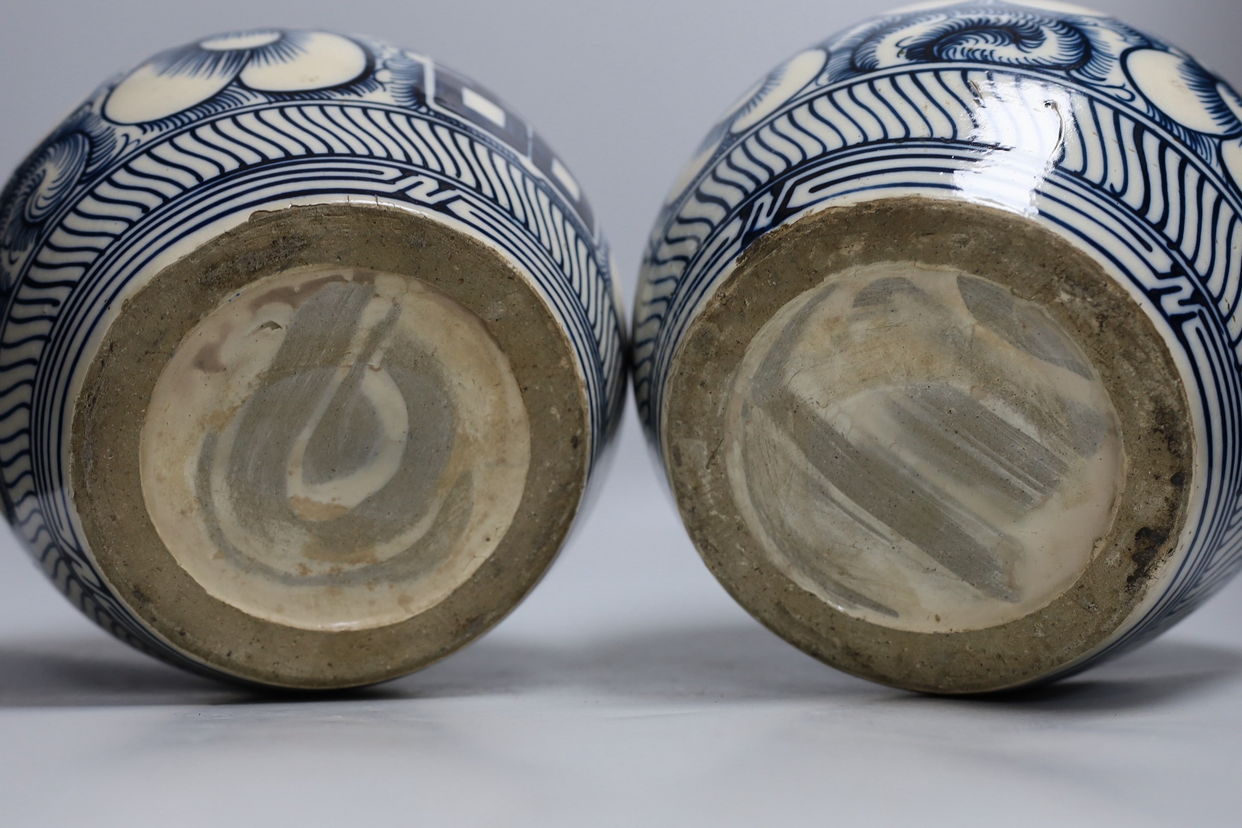 A pair of Chinese blue and white ‘Shuangxi’ jars and cover, 25cms high